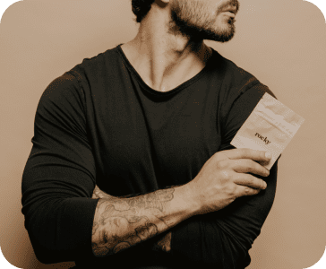A man holding a beige package with the text 'rocky' on it.